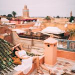 Photo Of Woman Wearing White Dress sitting at a roof in Marrakech