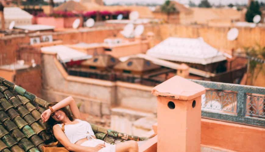 Photo Of Woman Wearing White Dress sitting at a roof in Marrakech